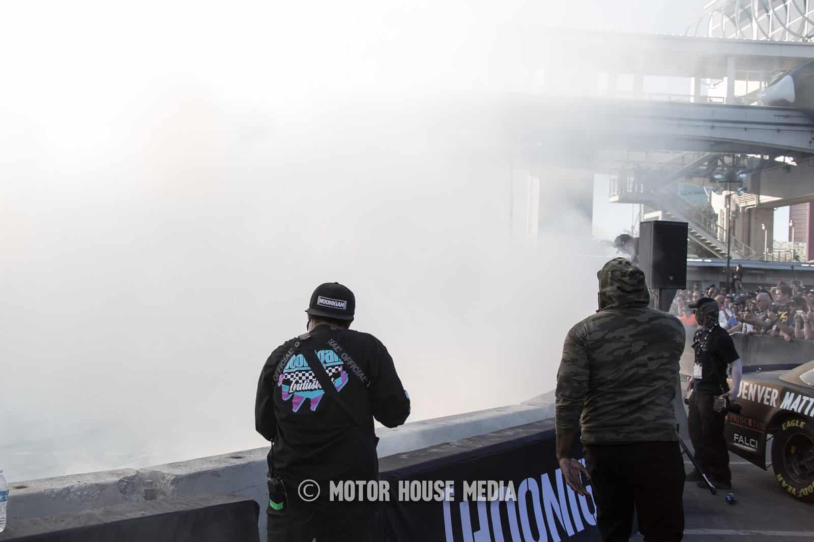 Peter Chrisikopoulos disappearing in tire smoke at the Hoonigan Sema Barnyard
