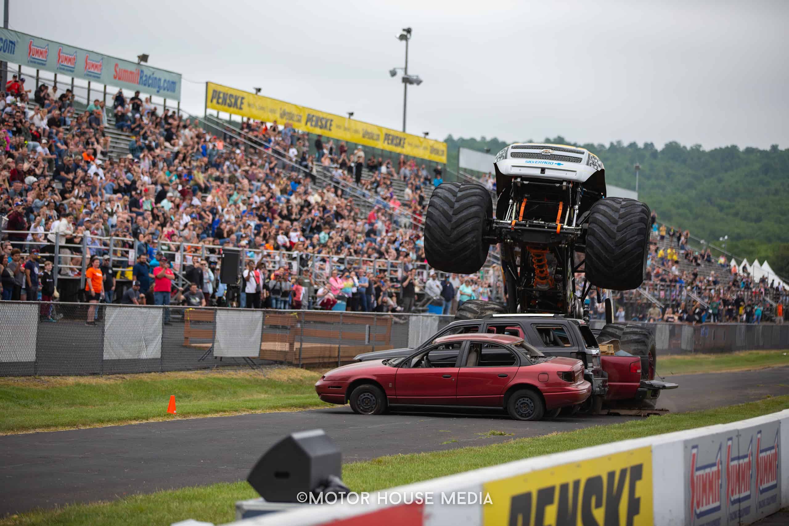Monster truck in action at The Turn 5 auto show featuring Cars, trucks & Jeeps