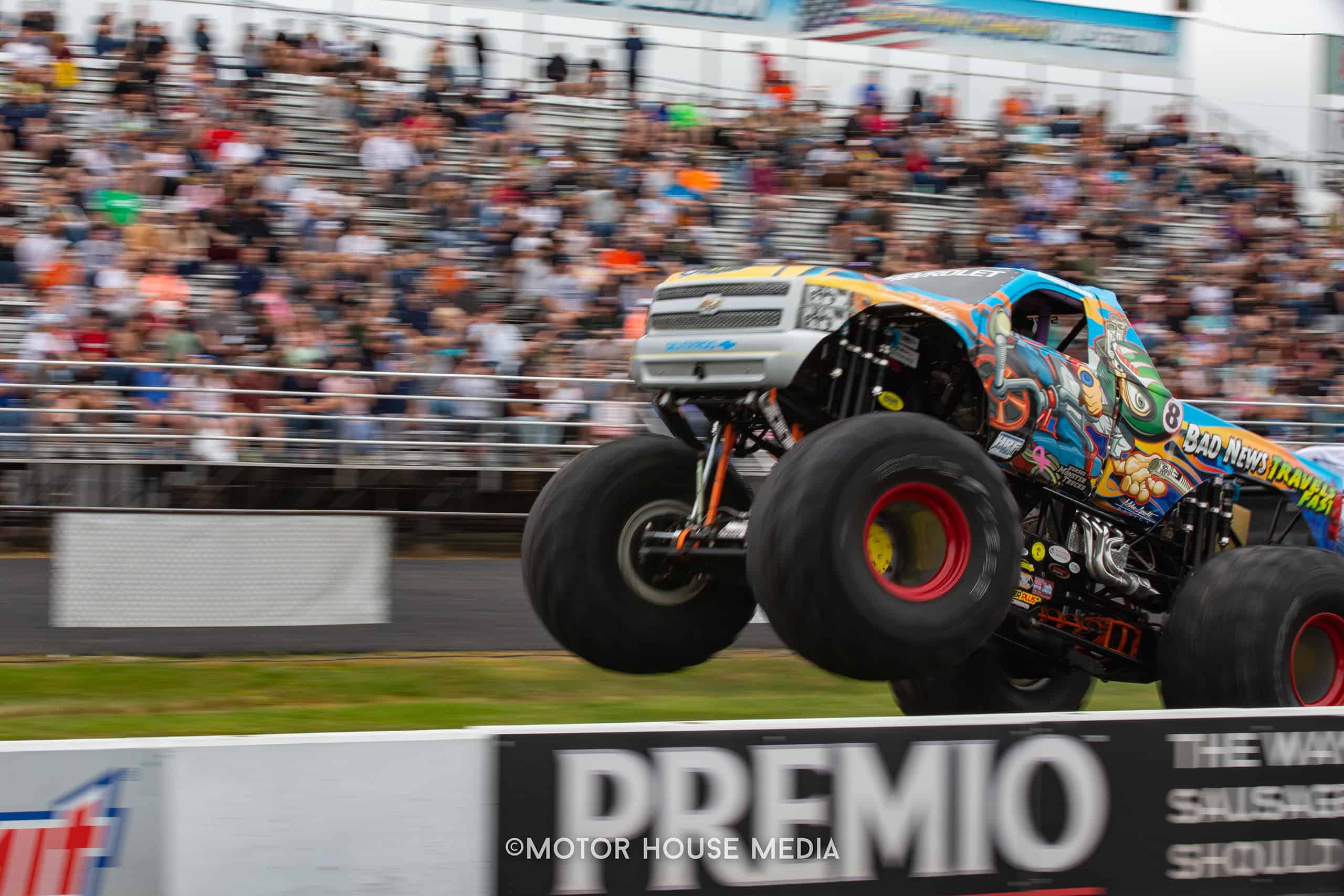 Monster truck in action at The Turn 5 auto show featuring Cars, trucks & Jeeps