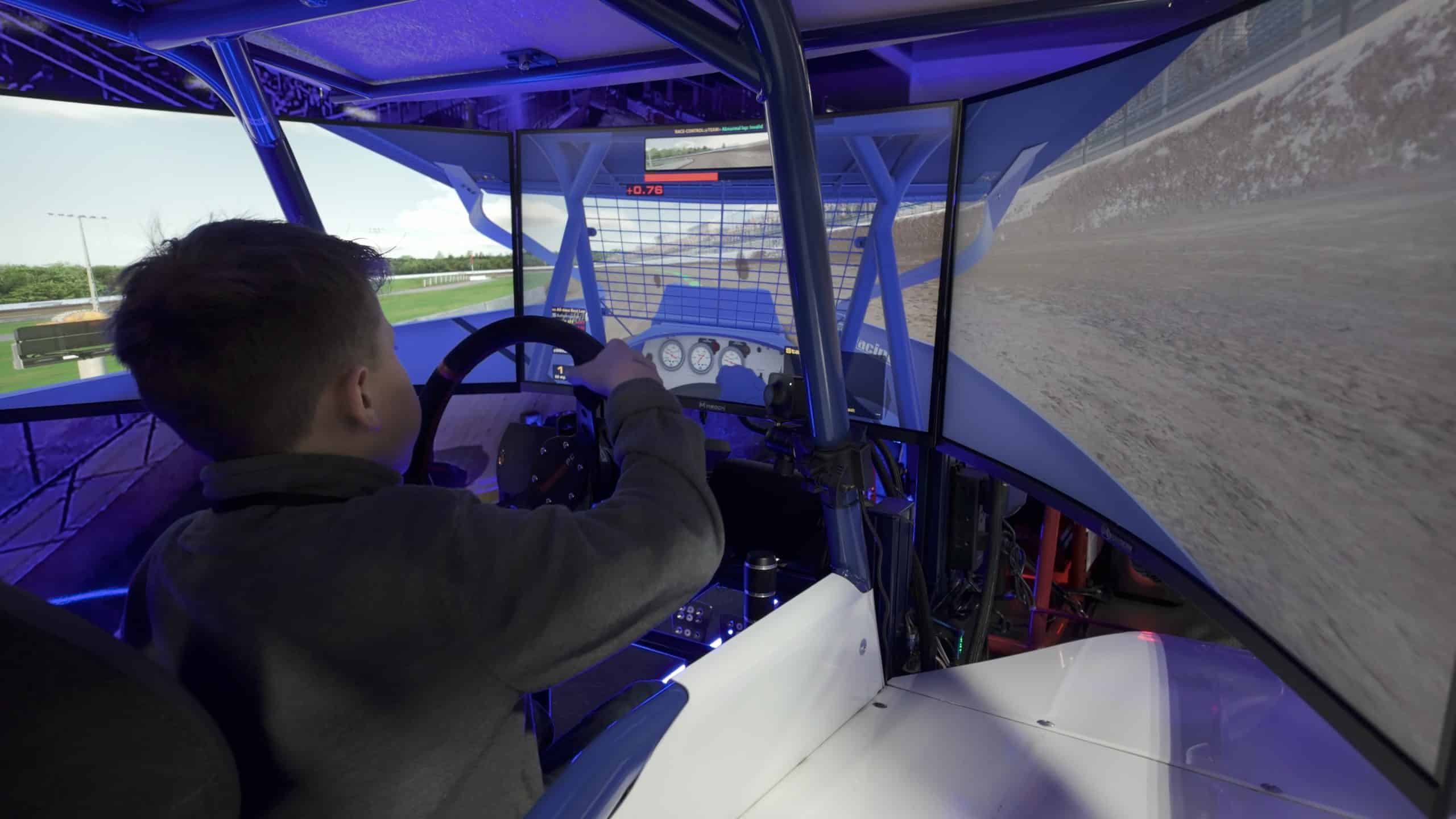 Young Kid racing in a dirt racing simulator